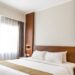 black sconce beside white bed